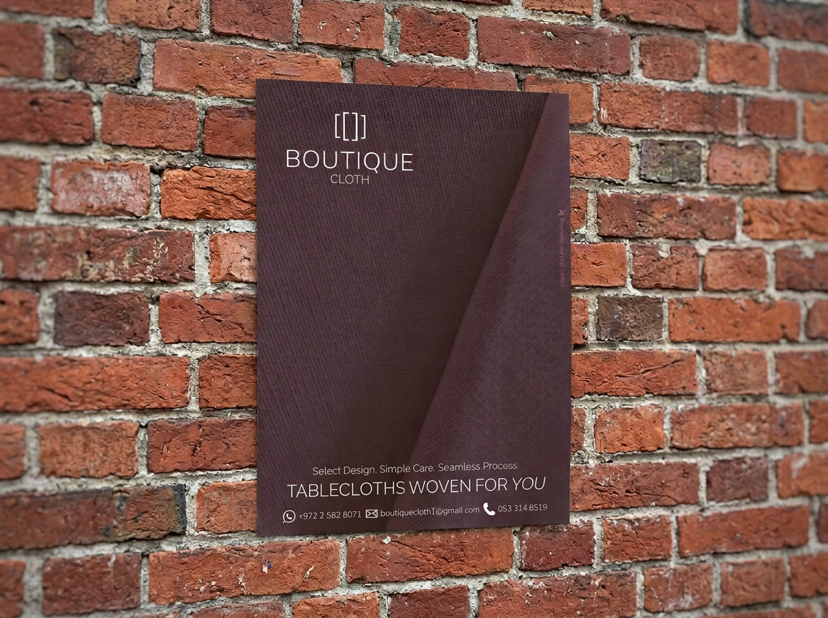 Boutique Cloth tablecloth ad shown as a printed flyer on a brick wall